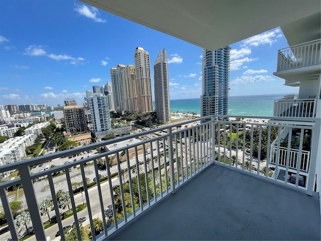 balcony featuring a city view and a water view
