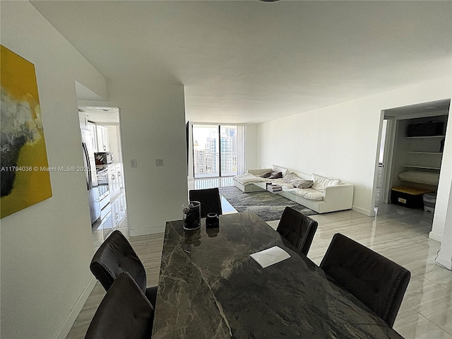dining space with baseboards and light tile patterned floors