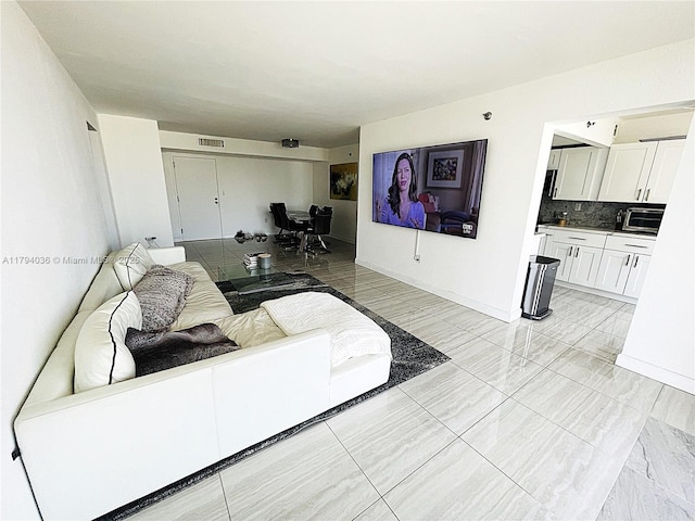 living room featuring visible vents and baseboards