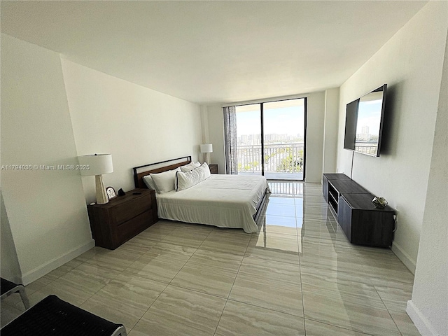 bedroom with baseboards and floor to ceiling windows