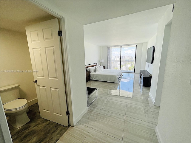 interior space featuring baseboards and expansive windows
