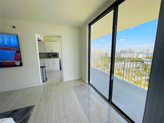 interior space featuring a view of city and baseboards