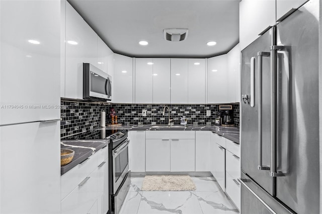 kitchen with marble finish floor, white cabinetry, appliances with stainless steel finishes, and modern cabinets