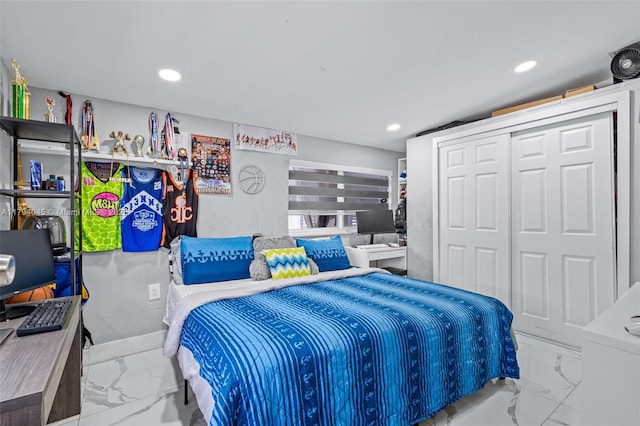 bedroom featuring recessed lighting, marble finish floor, and a closet