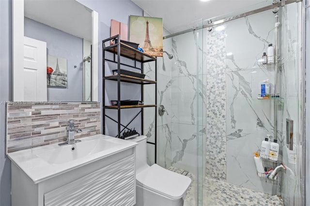 bathroom featuring a marble finish shower, decorative backsplash, vanity, and toilet