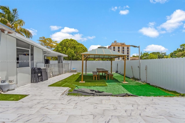 view of yard with a gazebo, a fenced backyard, and a patio area