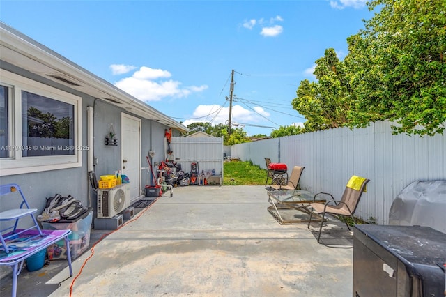 view of patio with a fenced backyard and ac unit