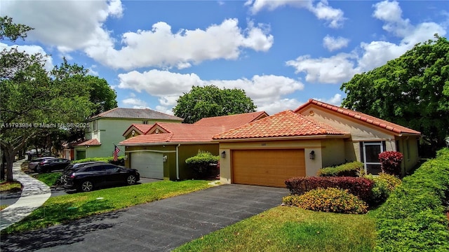 1583 Presidio Dr, Weston, FL 33327 - mediterranean / spanish house featuring a tiled roof, a garage, stucco siding, and asphalt driveway