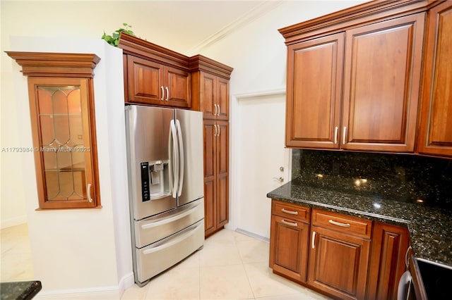 1583 Presidio Dr, Weston, FL 33327 - kitchen featuring stainless steel refrigerator with ice dispenser, tasteful backsplash, light tile patterned floors, range, and dark stone counters