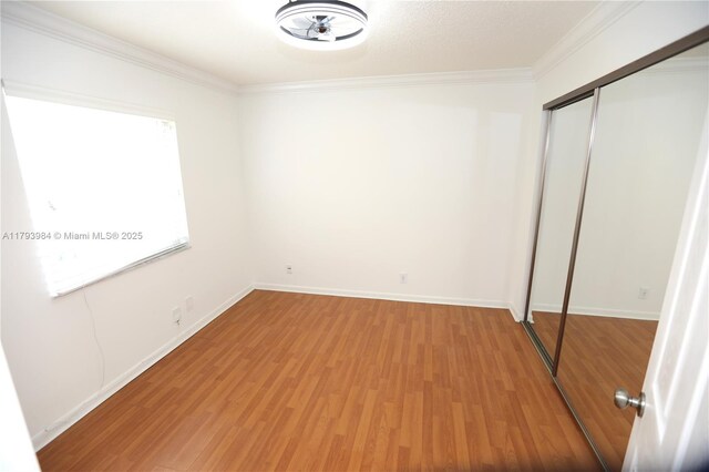 1583 Presidio Dr, Weston, FL 33327 - unfurnished bedroom featuring a closet, ornamental molding, light wood-style floors, and baseboards