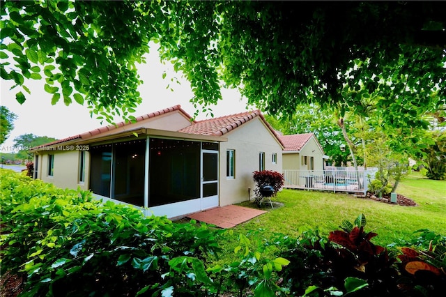 1583 Presidio Dr, Weston, FL 33327 - back of property featuring a tile roof, a sunroom, and stucco siding