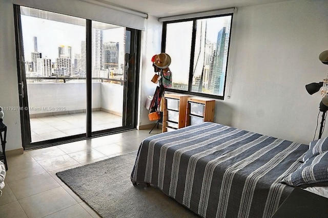1581 Brickell Ave Unit 1807, Miami, FL 33129 - bedroom featuring multiple windows, a city view, tile patterned flooring, and access to exterior
