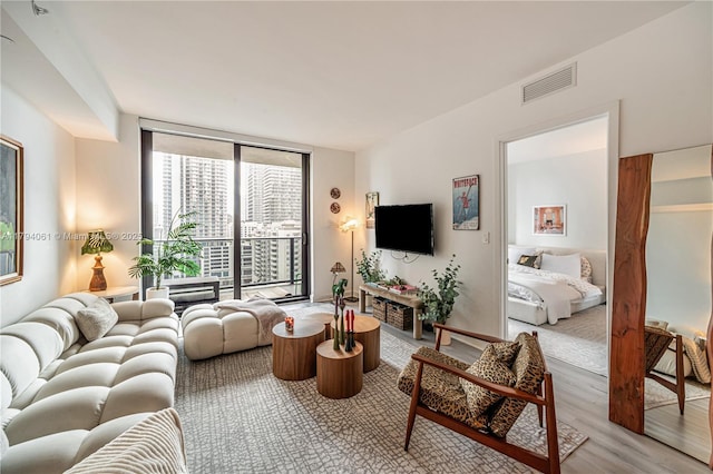 45 SW 9th St Unit 1204, Miami, FL 33130 - living area featuring a wall of windows, light wood finished floors, and visible vents