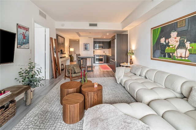 45 SW 9th St Unit 1204, Miami, FL 33130 - living area with a tray ceiling, wood finished floors, and visible vents