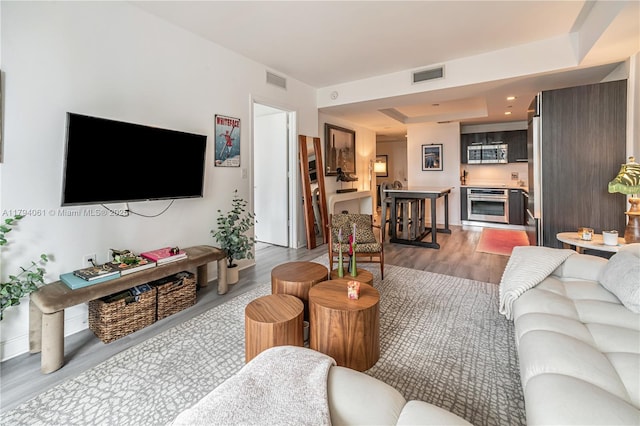 45 SW 9th St Unit 1204, Miami, FL 33130 - living area featuring a raised ceiling, wood finished floors, and visible vents