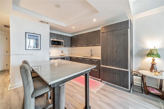 45 SW 9th St Unit 1204, Miami, FL 33130 - kitchen with a sink, stainless steel microwave, dark brown cabinetry, and visible vents
