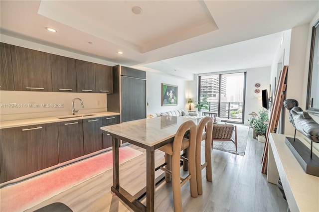 45 SW 9th St Unit 1204, Miami, FL 33130 - kitchen featuring light countertops, dark brown cabinetry, open floor plan, and a sink