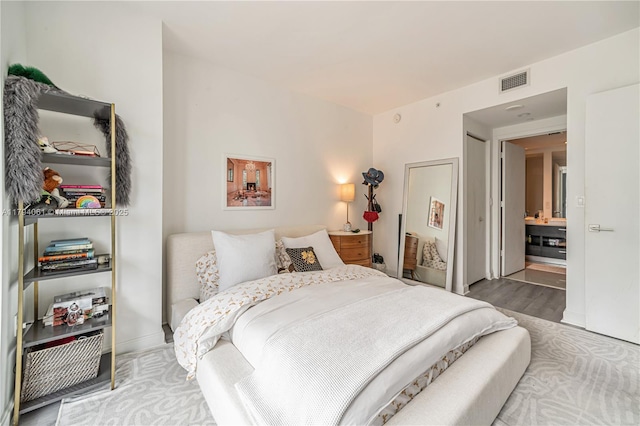 45 SW 9th St Unit 1204, Miami, FL 33130 - bedroom featuring visible vents, baseboards, and wood finished floors
