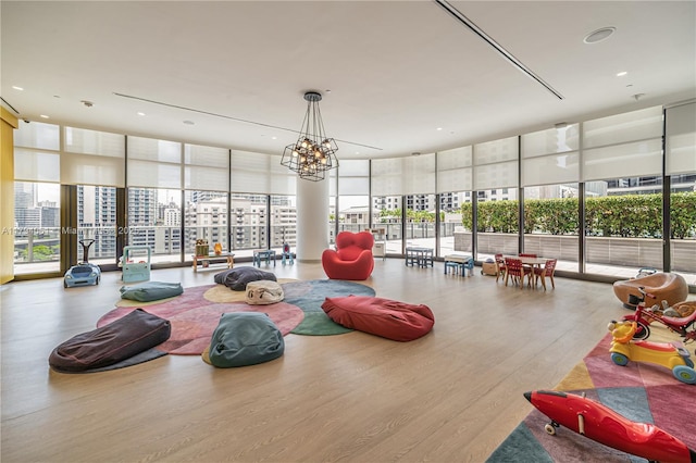 45 SW 9th St Unit 1204, Miami, FL 33130 - workout area featuring an inviting chandelier, expansive windows, wood finished floors, and a wealth of natural light