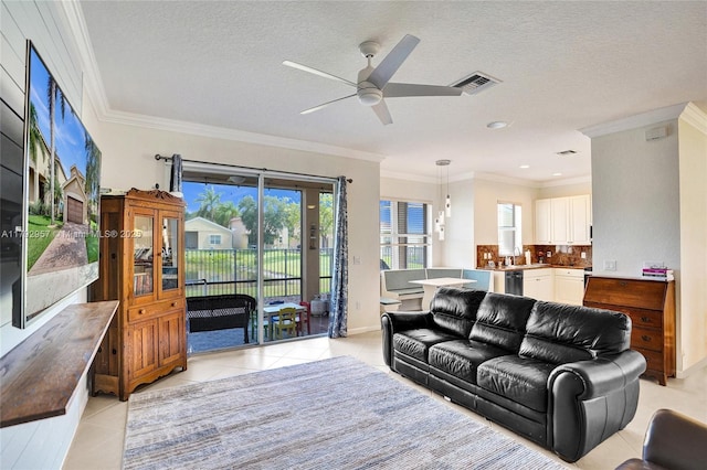 7643 Corkwood Ave, Boynton Beach, FL 33437 - living room featuring ceiling fan, light tile patterned flooring, crown molding, a textured ceiling, and baseboards