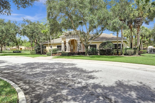 7643 Corkwood Ave, Boynton Beach, FL 33437 - view of front of house featuring stucco siding and a front lawn