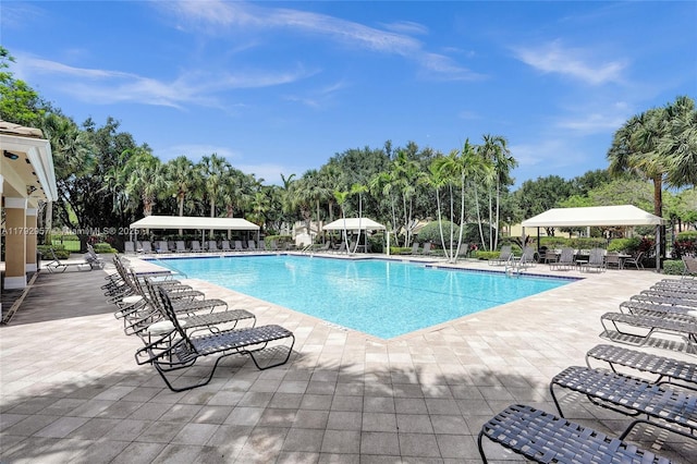 7643 Corkwood Ave, Boynton Beach, FL 33437 - community pool featuring a patio and view of scattered trees