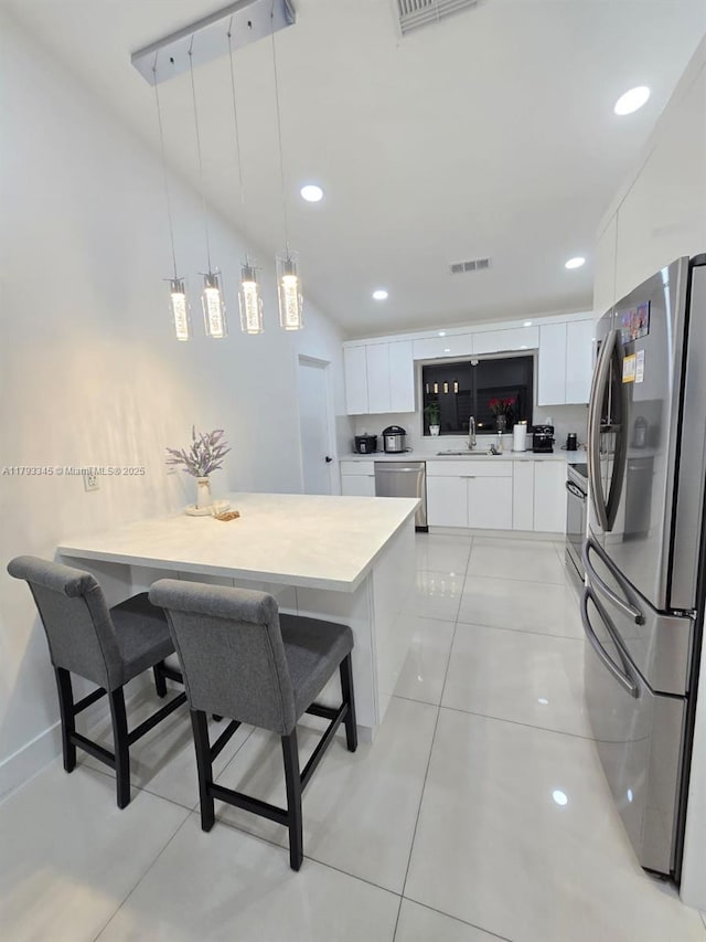 11015 SW 158th Ter, Miami, FL 33157 - kitchen featuring visible vents, a sink, light countertops, white cabinets, and stainless steel appliances