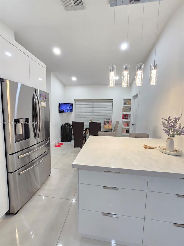 11015 SW 158th Ter, Miami, FL 33157 - kitchen with white cabinets, stainless steel fridge with ice dispenser, light tile patterned floors, visible vents, and modern cabinets