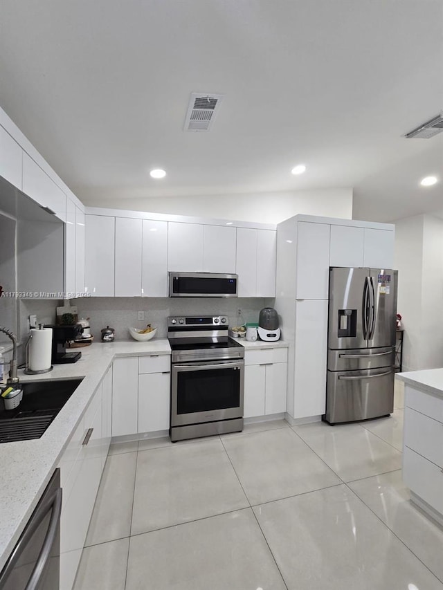 11015 SW 158th Ter, Miami, FL 33157 - kitchen featuring visible vents, a sink, modern cabinets, and stainless steel appliances