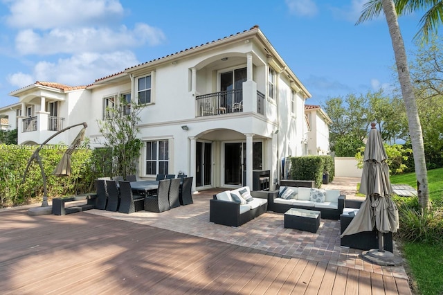 999 N Harbor Vw N, Hollywood, FL 33019 - rear view of property featuring outdoor lounge area, a wooden deck, a balcony, outdoor dining area, and stucco siding