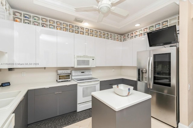 999 N Harbor Vw N, Hollywood, FL 33019 - kitchen featuring ornamental molding, gray cabinets, ceiling fan, and white appliances