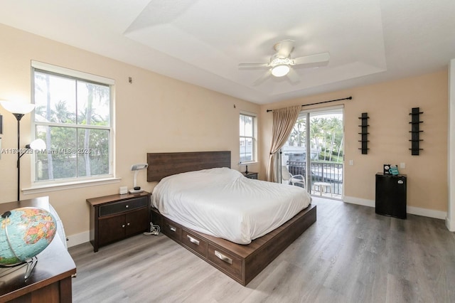 999 N Harbor Vw N, Hollywood, FL 33019 - bedroom featuring baseboards, ceiling fan, access to outside, a tray ceiling, and light wood finished floors