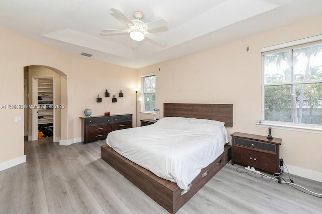 999 N Harbor Vw N, Hollywood, FL 33019 - bedroom with visible vents, arched walkways, light wood-style flooring, and multiple windows