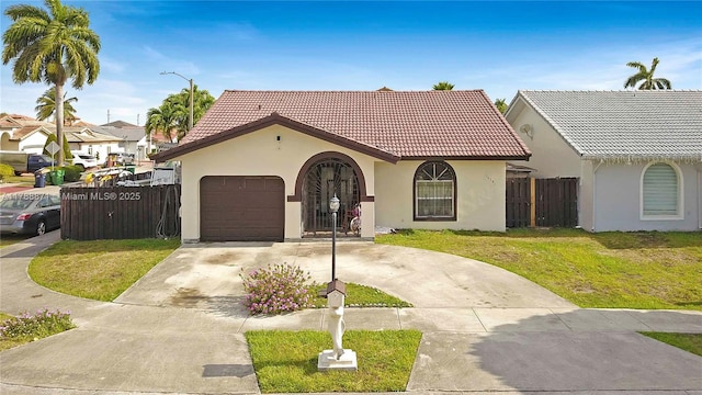 14391 SW 24th St, Miami, FL 33175 - mediterranean / spanish home with an attached garage, a tile roof, stucco siding, a front yard, and driveway