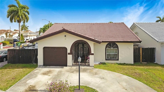 14391 SW 24th St, Miami, FL 33175 - mediterranean / spanish-style home with a tiled roof, a garage, fence, a front lawn, and stucco siding