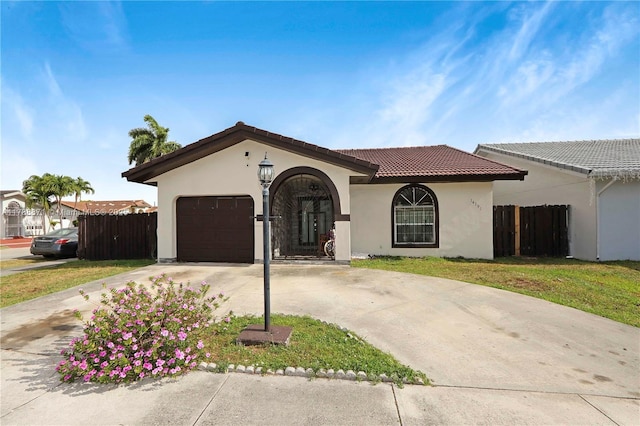 14391 SW 24th St, Miami, FL 33175 - mediterranean / spanish-style house with stucco siding, fence, a tile roof, and a garage