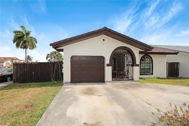 14391 SW 24th St, Miami, FL 33175 - view of front of house with stucco siding, fence, a front yard, and a garage