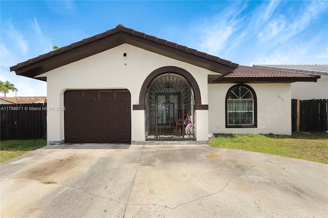 14391 SW 24th St, Miami, FL 33175 - mediterranean / spanish home featuring a garage, fence, stucco siding, a tiled roof, and driveway