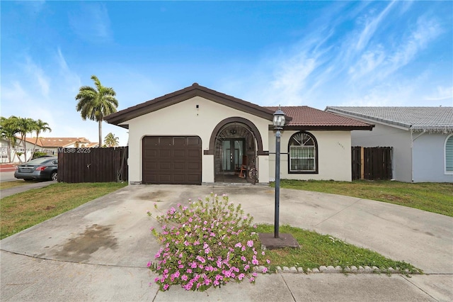 14391 SW 24th St, Miami, FL 33175 - view of front of property with fence, stucco siding, a tiled roof, concrete driveway, and an attached garage