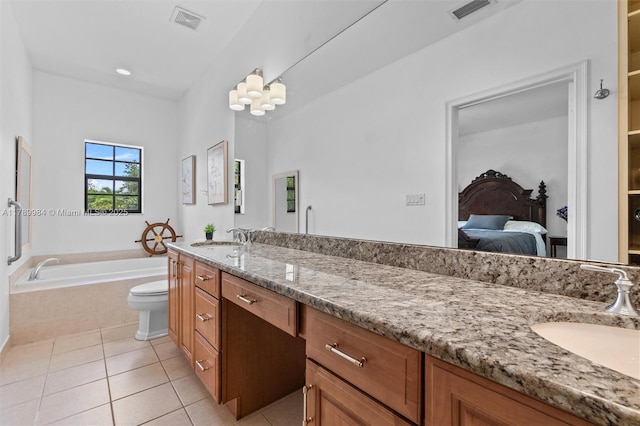 ensuite bathroom with visible vents, a garden tub, tile patterned floors, and vanity