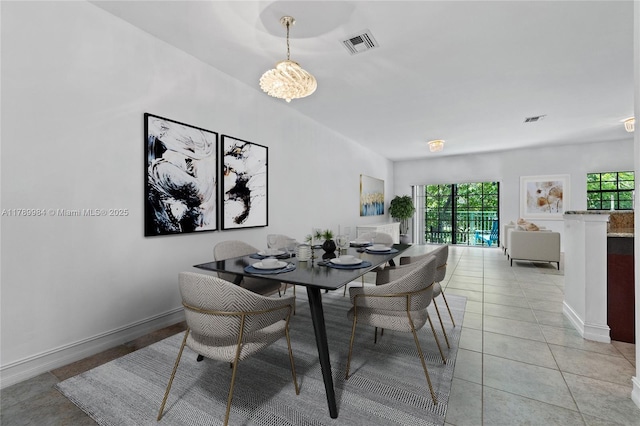 dining area with light tile patterned floors, baseboards, a chandelier, and visible vents