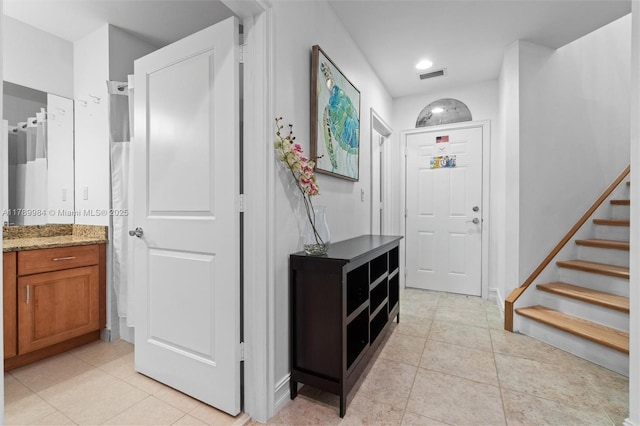 interior space featuring light tile patterned floors, recessed lighting, stairs, and visible vents
