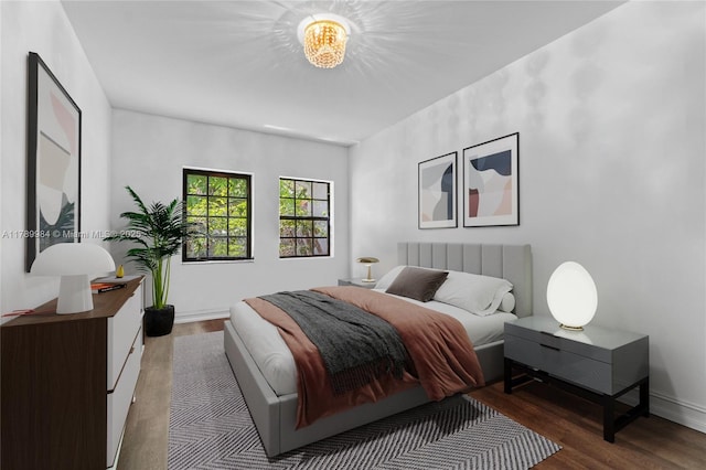 bedroom featuring baseboards and wood finished floors