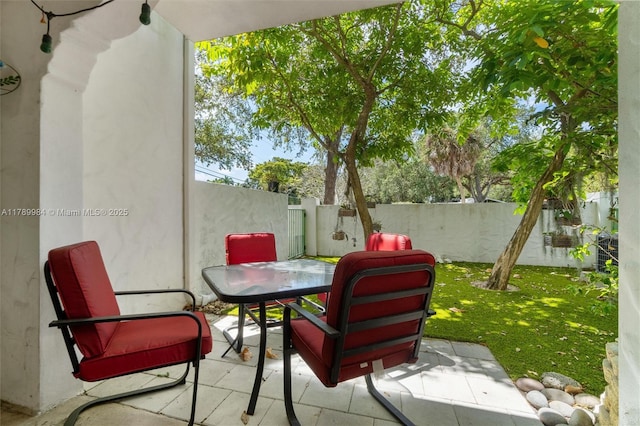 view of patio with outdoor dining area and a fenced backyard