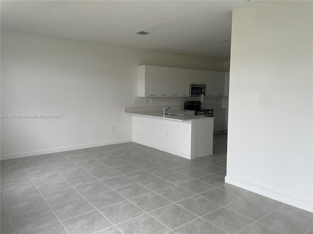 kitchen with visible vents, appliances with stainless steel finishes, light tile patterned floors, baseboards, and light countertops