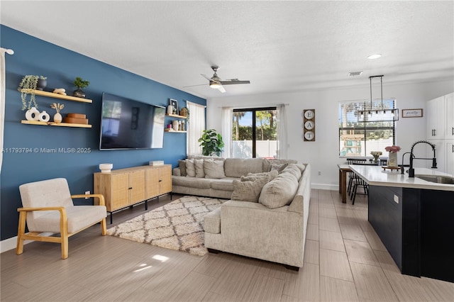4859 NW 55th Pl, Tamarac, FL 33319 - living area featuring plenty of natural light, a ceiling fan, a textured ceiling, baseboards, and recessed lighting