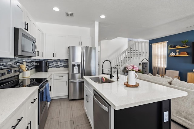 4859 NW 55th Pl, Tamarac, FL 33319 - kitchen with appliances with stainless steel finishes, a sink, open floor plan, tasteful backsplash, and recessed lighting