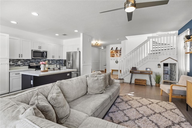 4859 NW 55th Pl, Tamarac, FL 33319 - living area featuring stairway, ceiling fan, light wood-style floors, recessed lighting, and a textured ceiling