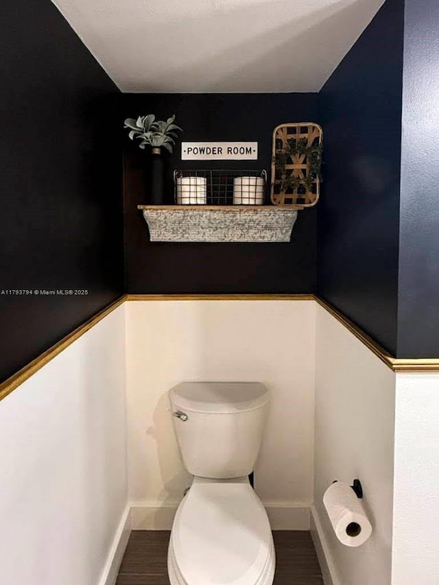 4859 NW 55th Pl, Tamarac, FL 33319 - bathroom with toilet, baseboards, and wood finished floors