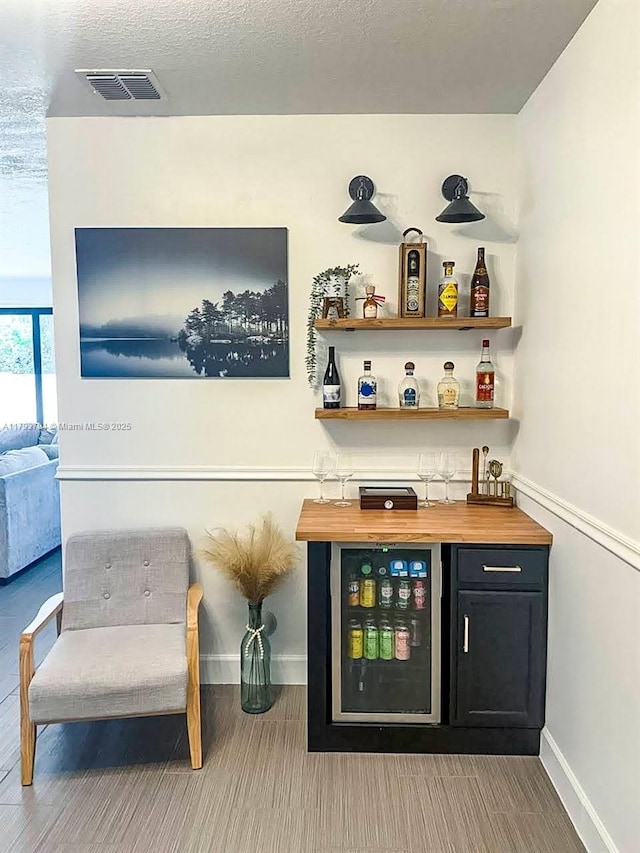4859 NW 55th Pl, Tamarac, FL 33319 - indoor dry bar with beverage cooler, baseboards, and wood finished floors